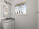 Bright bathroom showcasing granite countertop, a stylish sink and large window offering natural light at 327 Thornton Sw St, Atlanta, GA 30315