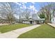Well-kept front lawn, long driveway, and attached carport at 327 Thornton Sw St, Atlanta, GA 30315