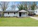 Single-story home with a well-maintained front yard, covered porch, and driveway at 327 Thornton Sw St, Atlanta, GA 30315