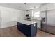 Well-lit kitchen featuring a granite island, stainless steel appliances, and white cabinets at 327 Thornton Sw St, Atlanta, GA 30315