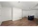 Open-concept area with wood floors and an island with granite countertop at 327 Thornton Sw St, Atlanta, GA 30315