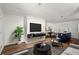 Bright living room with wood floors, modern furnishings, and an adjacent dining area at 327 Thornton Sw St, Atlanta, GA 30315