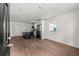 Open-concept room featuring wood floors, stainless steel appliances, and a granite island at 327 Thornton Sw St, Atlanta, GA 30315