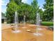 A modern splash pad with benches and lush green space in the background is perfect for hot summer days at 809 Hartford Sw Pl, Atlanta, GA 30310