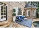 Brick home back patio with seating area and stylish outdoor furniture at 110 Mattison Cv, Atlanta, GA 30319