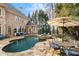 Backyard view featuring a swimming pool, hot tub, and patio seating at 110 Mattison Cv, Atlanta, GA 30319