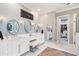 Bright bathroom with double vanity, modern lighting, and an entrance to the walk-in closet at 110 Mattison Cv, Atlanta, GA 30319