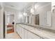 Bathroom featuring double sinks, granite countertop, and modern mirrors and lighting at 110 Mattison Cv, Atlanta, GA 30319