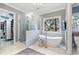 Bathroom featuring a luxurious freestanding tub, a glass shower and access to a walk-in closet at 110 Mattison Cv, Atlanta, GA 30319