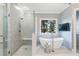 A renovated bathroom with a glass shower, a freestanding tub, and modern fixtures at 110 Mattison Cv, Atlanta, GA 30319