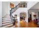 Spacious foyer featuring hardwood floors, a staircase with rod iron spindles, and an arched doorway at 110 Mattison Cv, Atlanta, GA 30319