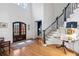 Inviting foyer with hardwood floors, a grand staircase, and plenty of natural light from the front door at 110 Mattison Cv, Atlanta, GA 30319