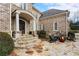 Inviting front porch with stone steps and a cozy seating area with a fire pit at 110 Mattison Cv, Atlanta, GA 30319