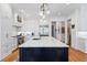 Bright kitchen boasts marble countertops, stainless steel appliances and a large dark blue kitchen island at 110 Mattison Cv, Atlanta, GA 30319