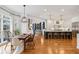 Open concept kitchen and dining area with hardwood floors and many windows at 110 Mattison Cv, Atlanta, GA 30319