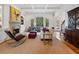 Cozy living room features a fireplace, built-in shelving, and a large arched window overlooking the backyard at 110 Mattison Cv, Atlanta, GA 30319