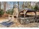 Stone outdoor kitchen and fireplace with grill, sink, and bar area at 110 Mattison Cv, Atlanta, GA 30319