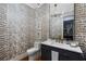 Stylish powder room featuring unique wallpaper, marble countertop vanity, and modern fixtures at 110 Mattison Cv, Atlanta, GA 30319