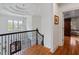 Second story foyer featuring hard wood floors, iron railings, and an elegant chandelier at 110 Mattison Cv, Atlanta, GA 30319