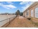 The backyard features a wood deck with patio furniture, a white fence and well-maintained landscaping at 217 Chad Ln, Loganville, GA 30052