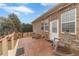 Outdoor patio with seating, brick base, a white door, and landscaped surroundings at 217 Chad Ln, Loganville, GA 30052