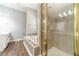 Bathroom view showcasing a luxurious soaking tub, separate shower, and vanity with mirror at 217 Chad Ln, Loganville, GA 30052