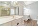 Bathroom featuring dual sinks, white cabinetry, and a shower with glass door at 217 Chad Ln, Loganville, GA 30052
