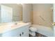 Bright bathroom features a white vanity, wood-look flooring, and a shower-tub combo with grab bars at 217 Chad Ln, Loganville, GA 30052