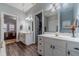 Dual vanities and an arched doorway create an open and airy bathroom atmosphere at 217 Chad Ln, Loganville, GA 30052