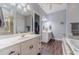 Bathroom featuring a double sink vanity and a separate shower and bathtub at 217 Chad Ln, Loganville, GA 30052