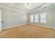 Bedroom boasts neutral walls, plush carpet, crown molding, recessed lights, and abundant natural light at 217 Chad Ln, Loganville, GA 30052