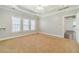 Spacious bedroom with plush carpeting, tray ceilings, recessed lighting, and a ceiling fan at 217 Chad Ln, Loganville, GA 30052