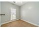 Neutral bedroom features carpet flooring, a window bringing in natural light, and gray-painted walls at 217 Chad Ln, Loganville, GA 30052