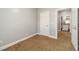 Neutral bedroom with a view to the kitchen through an open door and carpet flooring at 217 Chad Ln, Loganville, GA 30052
