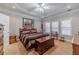 Comfortable bedroom featuring a tray ceiling, three windows and warm, neutral decor at 217 Chad Ln, Loganville, GA 30052