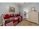 Cozy bedroom featuring a daybed with red accents, carpeted floors, and a bright window at 217 Chad Ln, Loganville, GA 30052