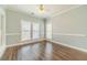 Comfortable bedroom with hardwood floors, natural light, and neutral color palette at 217 Chad Ln, Loganville, GA 30052