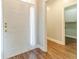 Light-filled entryway featuring wood-look floors and a white front door with glass sidelights at 217 Chad Ln, Loganville, GA 30052