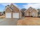 Charming brick home featuring a two-car garage and well-manicured lawn at 217 Chad Ln, Loganville, GA 30052