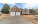 Charming brick home with a two-car garage and well-maintained front yard with mature trees at 217 Chad Ln, Loganville, GA 30052