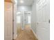 Hallway view featuring carpet flooring, white doors, and neutral-colored walls at 217 Chad Ln, Loganville, GA 30052