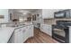 Modern kitchen boasts white cabinetry, stainless steel appliances, and an open layout at 217 Chad Ln, Loganville, GA 30052