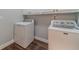 Laundry room features a modern washer and dryer, white cabinets, and vinyl floors at 217 Chad Ln, Loganville, GA 30052