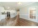 Open-concept kitchen and living area with modern white cabinets and stainless steel appliances at 217 Chad Ln, Loganville, GA 30052