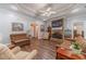 Inviting living room with a stone fireplace, hardwood floors, and plenty of seating at 217 Chad Ln, Loganville, GA 30052