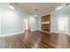 Spacious living room features hardwood floors, a stone fireplace, and recessed lighting at 217 Chad Ln, Loganville, GA 30052