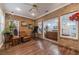 Cozy sun room with brick walls, natural light, and a view into the living room at 217 Chad Ln, Loganville, GA 30052