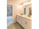 Bathroom featuring a double sink vanity with white cabinets, gray tile floors, and a bath tub at 2475 Adair Ridge Ct, Decatur, GA 30034