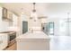 Bright kitchen features stainless appliances, quartz countertops, a central island, and modern lighting at 2475 Adair Ridge Ct, Decatur, GA 30034