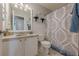 Bright bathroom features a granite countertop, white cabinetry, and a decorative shower curtain at 557 Bradford Park, Loganville, GA 30052